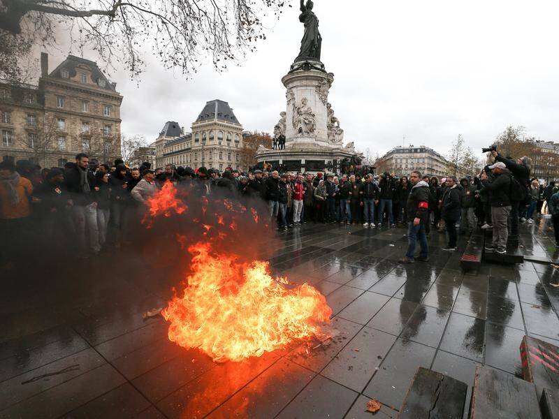 High school students demonstrate against new fees as anti-government fervor grips Paris.