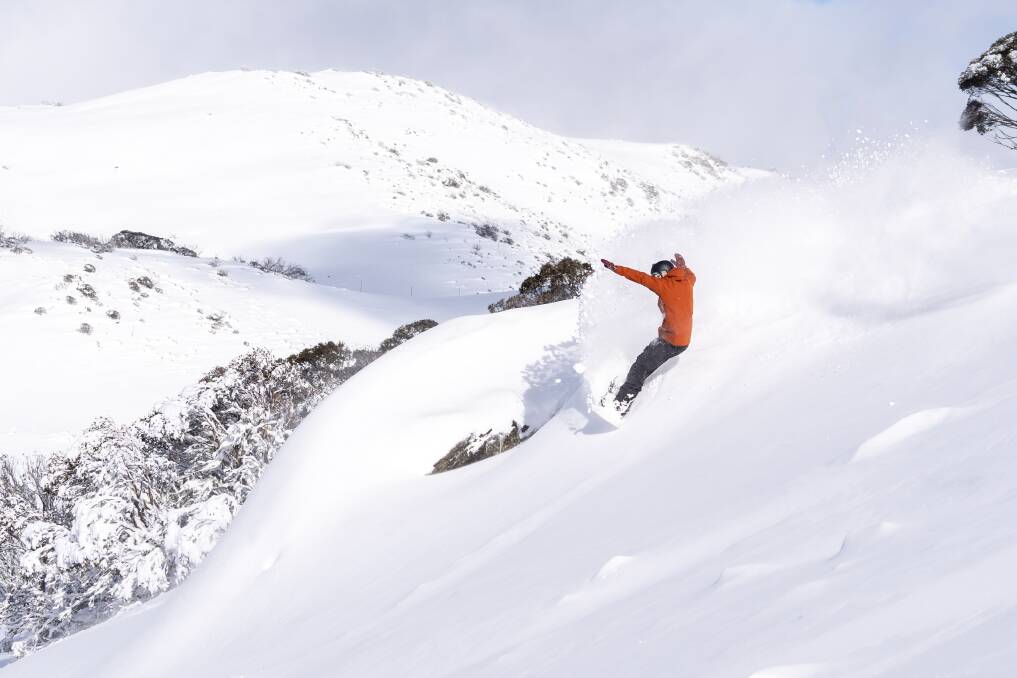 IN DOUBT: A snowboarder takes to the slopes in September after spring snowfall. Picture: FALLS CREEK 