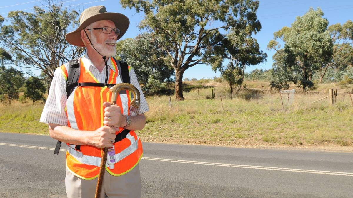 CENTRAL WEST PILGRIMAGE: Anglican Bishop Ian Palmer on his way into Orange yesterday. Photo: STEVE GOSCH 				                 0203sgwalk5