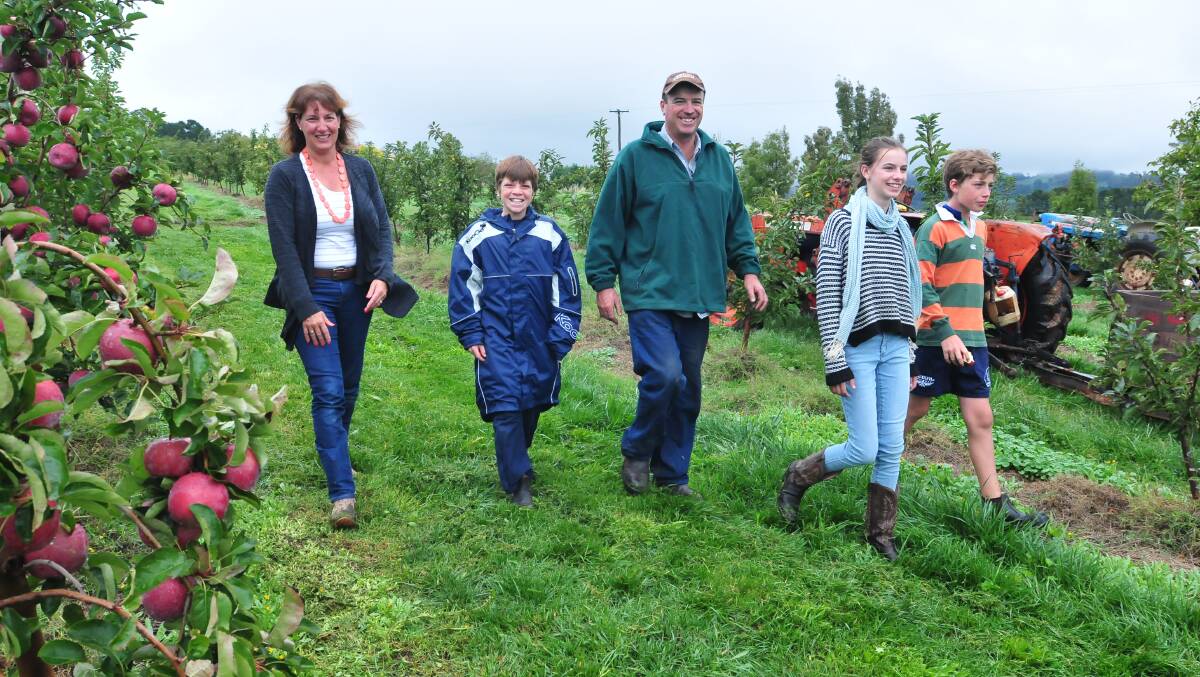 LIVING THE DREAM: Jayne, Harry, Tim, Ellie and Tom West on their orchard. Photo: JUDE KEOGH