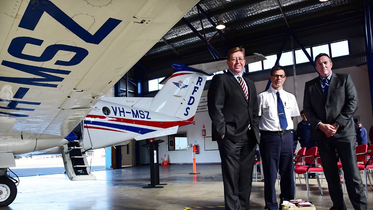 Member for Dubbo Troy Grant, Clinical Educator at the Aeromiedical Control Centre Jonathan Newman and the RFDS CEO Greg Sam at the Royal Flying Doctor Service base at Dubbo airport on Monday. Photo: BELINDA SOOLE