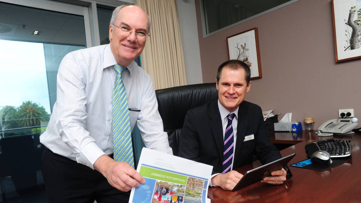 Dubbo City Council acting general manager David Dwyer and mayor Mathew Dickerson begin to review the Local Government Review Panel's final report. Photo: BELINDA SOOLE