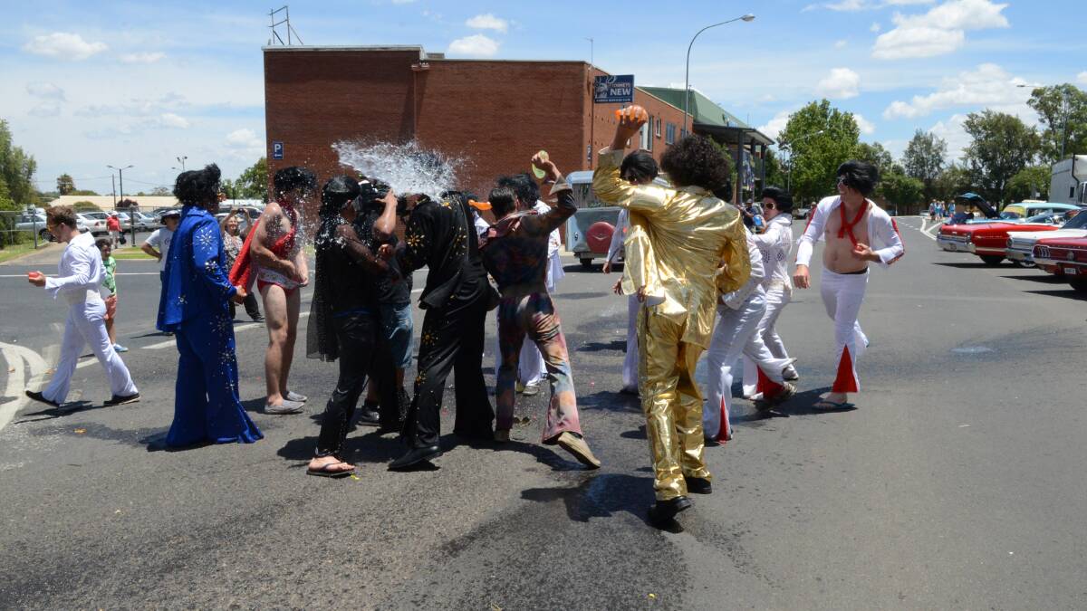 As temperatures reached 33 degrees on the Saturday of the 2014 Parkes Elvis Festival these Elvii decided a water fight was the way to keep cool. Photos: RENEE POWELL. 