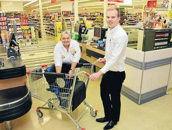 Dubbo Coles service manager, Sharon Cusack and assistant manager, Anthony Finch, with the specially-designed shopping trolley.
Photo: BELINDA SOOLE