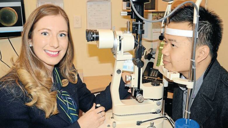 Dubbo Specsavers optometrist Yvonne Gilmour doing an eye test on Lincoln Ho, as part of Macular Degeneration Awareness Week, which began on Monday. Photo: TAYLOR JURD