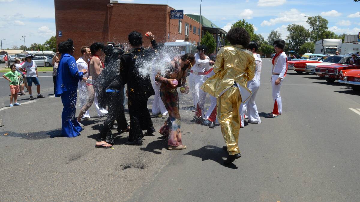 As temperatures reached 33 degrees on the Saturday of the 2014 Parkes Elvis Festival these Elvii decided a water fight was the way to keep cool. Photos: RENEE POWELL. 