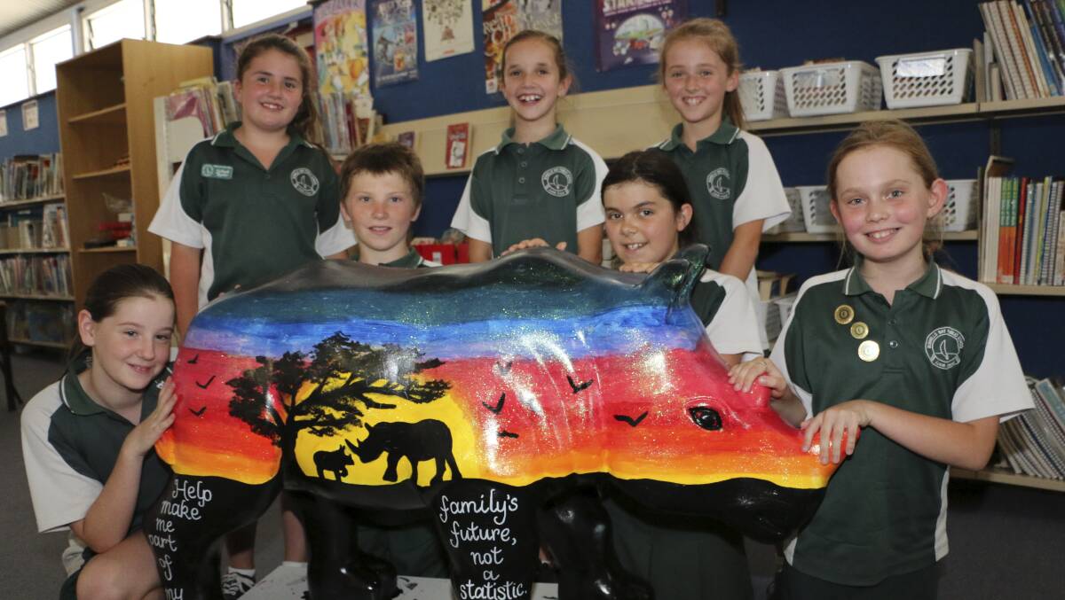 Students from Bonnells Bay Primary School with Bob the rhino. They painted Bob for Taronga Zoo's project - Taronga Wild! Rhinos and won the Creative Genius Competition. From left, Ashlee, Ellee, Tyler Carli, Carolee, Ruby, Tiara. December 2013. PHOTO:  Jamieson Murphy.