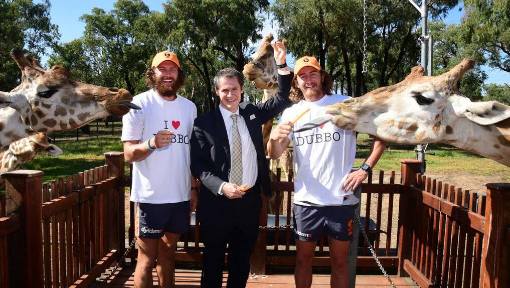 Greater Western Sydney Giants Sam Reid (left) and Dylan Addison with mayor Mathew Dickerson at Westerns Plains Zoo on Tuesday. Photo: Belinda Soole