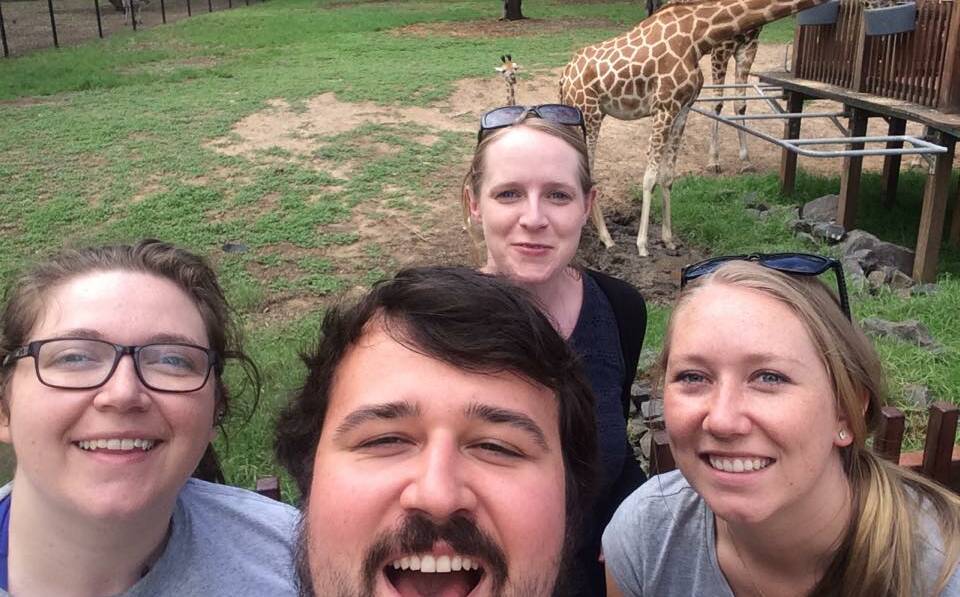 Rotaract members Gabrielle Dickert from Canada, Stephen Santos-Mocon from Canada, (back) Liz Doubtfire from New Zealand and Courtney Krahe from Sydney capture their moment with the giraffes at Taronga Western Plains Zoo during the East Coast Trip. Photo contributed.