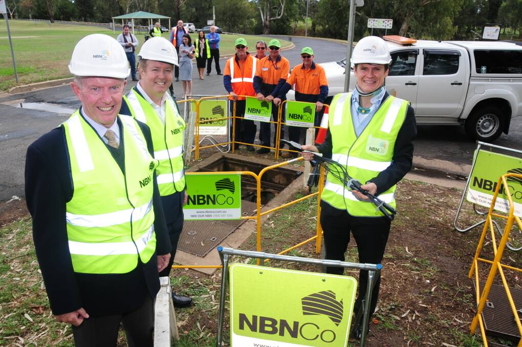 Federal Member for Parkes Mark Coulton, NBN Co spokesperson Darren Rudd and Dubbo mayor Mathew Dickerson at the official start of NBN construction at Dubbo. Back: Chris Smith, Geoff Swindle, Tony Ensbey and Lonnie Penrose watch on with interest. Photo: JOSH HEARD