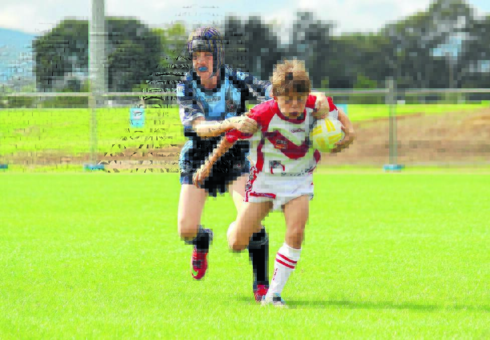 RUNAWAY: Mudgee's Josh Clay (right) tries to escape the Bloomfield defence in under 11s rugby league on Saturday. PHOTO: DARREN SNYDER