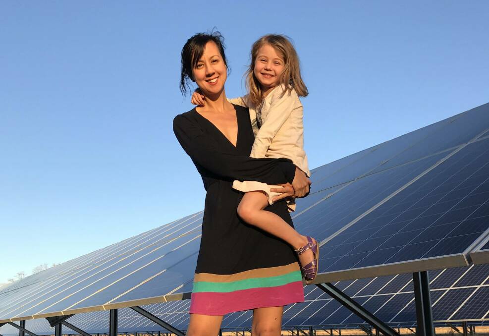 Narromine's Karin Stark with her daughter Noa in front of their solar panels. Picture: Supplied