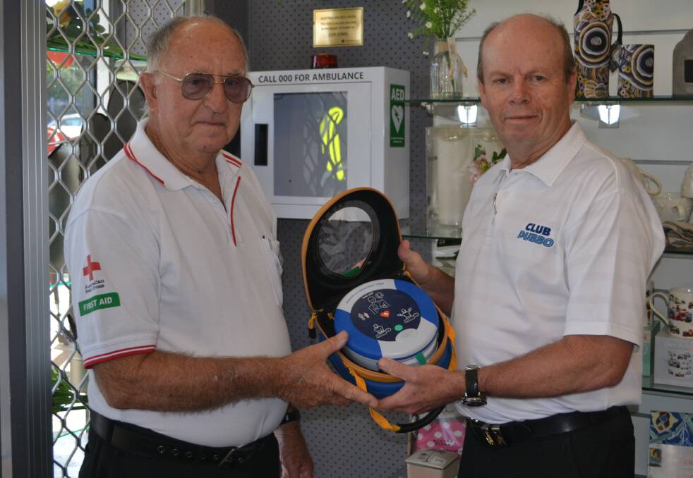 GET INVOLVED: Australian Red Cross Dubbo first aid trainer George Chapman and Club Dubbo CEO Rod Firth with the new defibrillator installed on Tuesday. Photo: ORLANDER RUMING