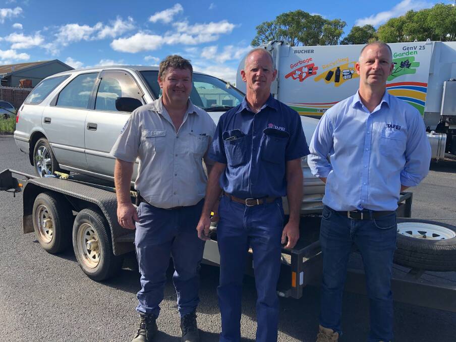 SKILLS: Dubbo Regional Councils acting team leader compliance Mark Ross with TAFE NSW Dubbos technical officer Jon Mancer and head teacher automotive Jeremy Reid in front of one of the impounded cars. Photo: CONTRIBUTED