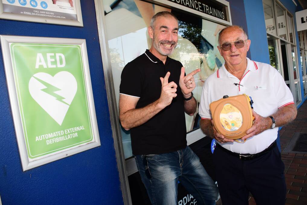 KNOWLEDGE IS POWER: Former yellow Wiggle Greg Page has donated five AEDs to Dubbo first aid trainer George Chapman. They will be installed in Wellington. Photo: AMY McINTYRE
