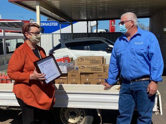 THANKS: Rhonda Gleeson presenting Mining Camps Australia general manager Jim Montague with a certificate. Photo: DAN SULLIVAN