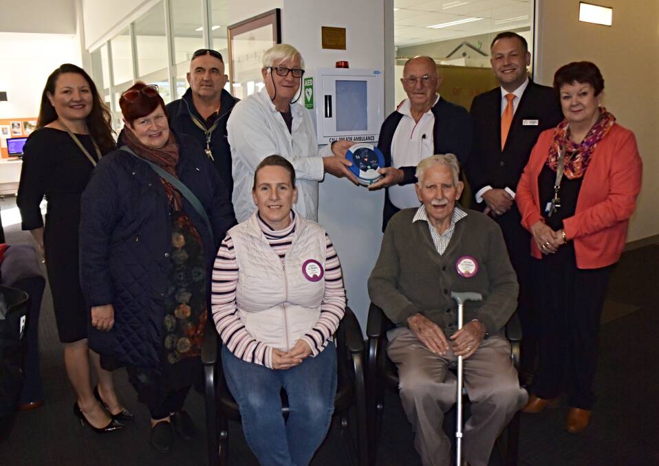 LAST ONE: Mark Vale and George Chapman celebrating the final defibrillator handover with council, the Lions Club, and the Dubbo Neighbourhood Centre. Photo: ORLANDER RUMING