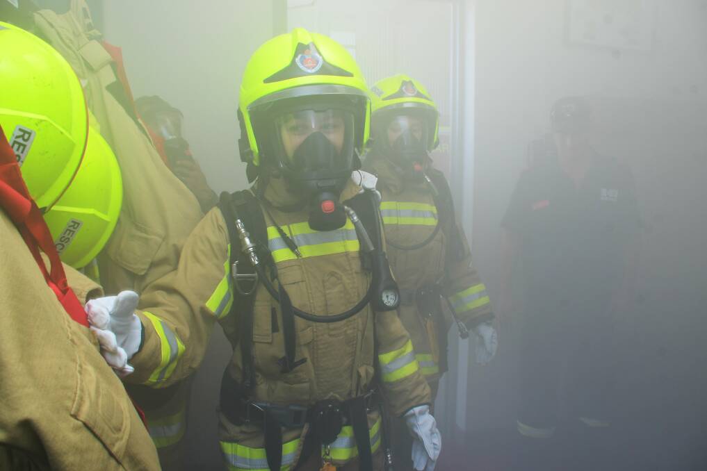 RESCUE OPERATION: Journalist Orlander Ruming checking a smoke-filled room for anyone in need of rescue. Photo: AMY McINTYRE