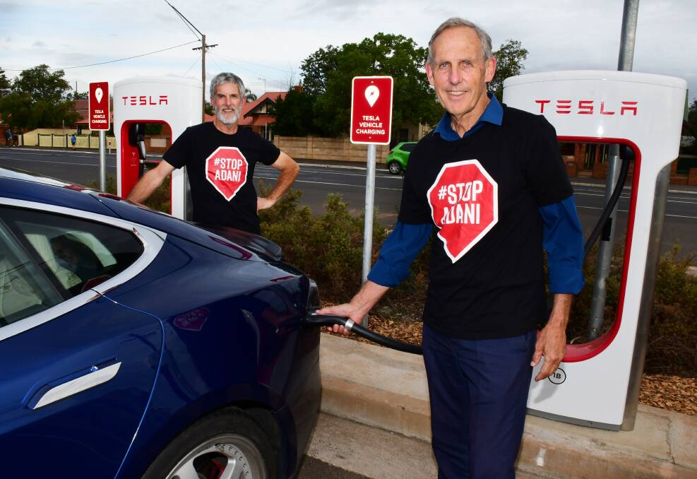 CALLING FOR ACTION: Paul Thomas and Bob Brown using the electric car chargers during their stop in Dubbo. Photo: BELINDA SOOLE