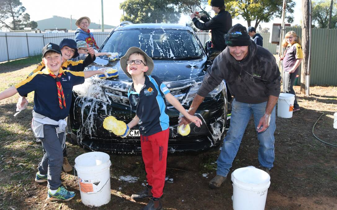 WORKING AT THE CAR WASH: Hamish Kerr, Jacob Lynch, Lachlan Kerr, Jack Arnold and Shane Rayment working hard at teh 1st Dubbo Scout Group car wash. Photo: AMY McINTYRE