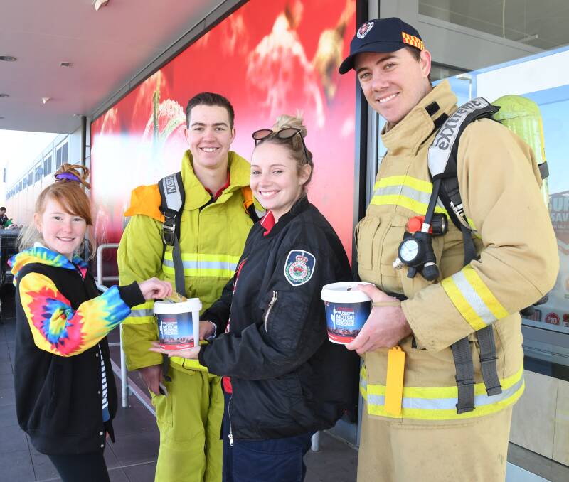 SUPPORTING THE CAUSE: Chloe Bacon donating money to Celeste Smith, Trent Clarke and Aaron Ferguson. Photo: AMY McINTYRE