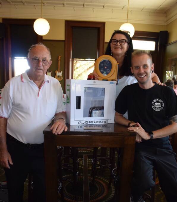 CAMPAIGN: George Chapman, Jen Cowley and  Ryan Mackintosh preparing to install the defibrillator at the Old Bank. Photo: ORLANDER RUMING