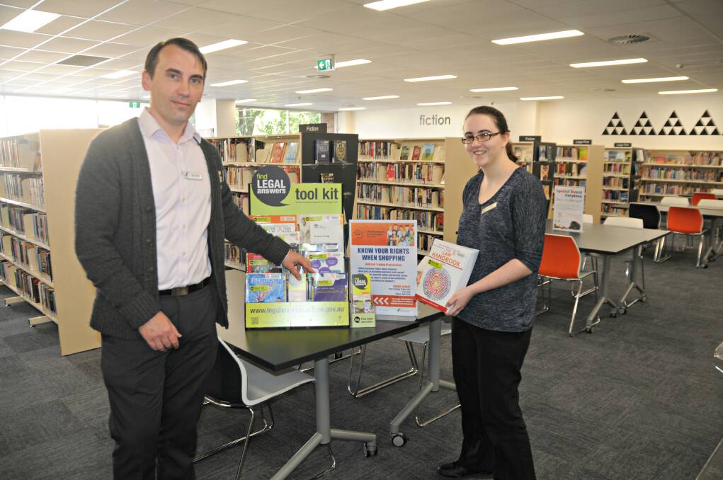 Macquarie Regional Library Dubbo branch manager Peter Irwin and Erin Barwick are urging the community to know their shopping rights this week. Photo: ORLANDER RUMING