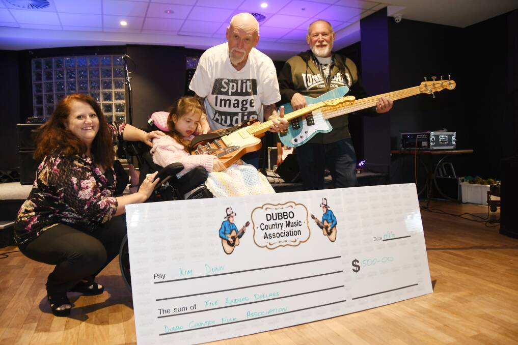 SOMETHING TO SING ABOUT: Kim Dunn and Sarah Bromhead-Dunn with Dubbo Country Music Association's Trevor Hannan and Shane Staffy who are handing over the money raised from a recent raffle. Photo: AMY McINTYRE