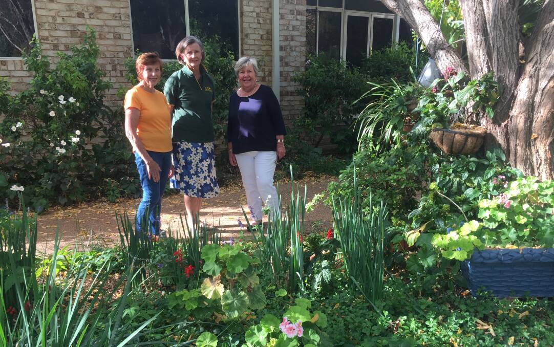 GOOD CAUSE: Can Assist volunteers Melva Blake, Prue Thompson and Fitz McKay at one of the open gardens. Photo: ORLANDER RUMING
