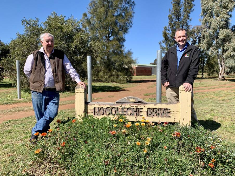  NEW LOOK: Firgrove Executive Committee member Ross Sawtell and Dubbo mayor Ben Shields with one of the signs in the estate that will be sanded and repainted. Photo: CONTRIBUTED