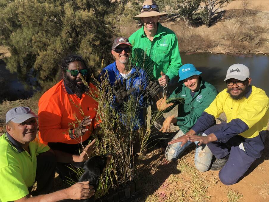 TREE DAY: Stephen Everson with Tango the kelpie, Bill Collis, Dave Harris, Rodney Price, Shae Shipp and Luke Boney getting their hands dirty in preparation for National Tree Day this weekend. Photo: CONTRIBUTED