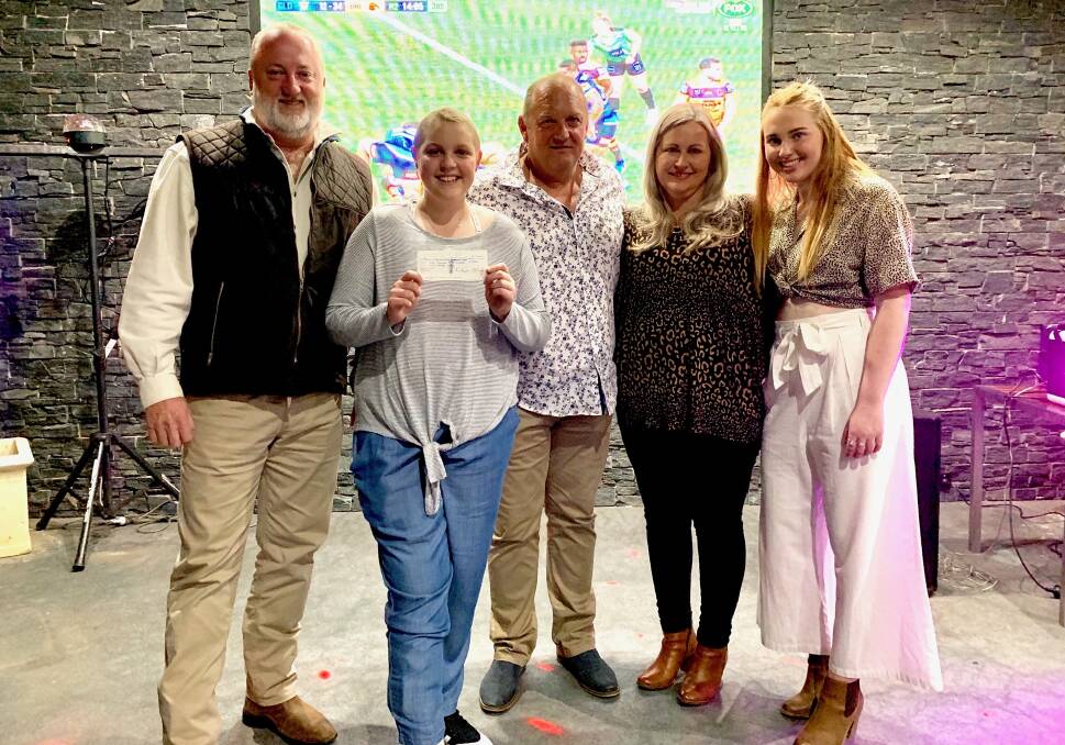 BUILDING COMMUNITY: Rotary Club of Dubbo South president Brett McCarthy presenting Molly Croft and her family John, Ange and Maddi, with $4960 towards the campaign. Photo: CONTRIBUTED