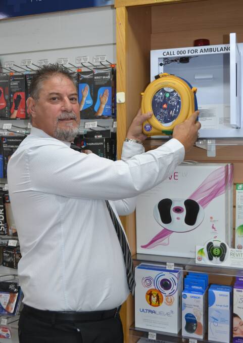 SAVING LIVES:  Dubbo RSL's Gus Lico installing the campaign's first defibrillator. Photo: ORLANDER RUMING