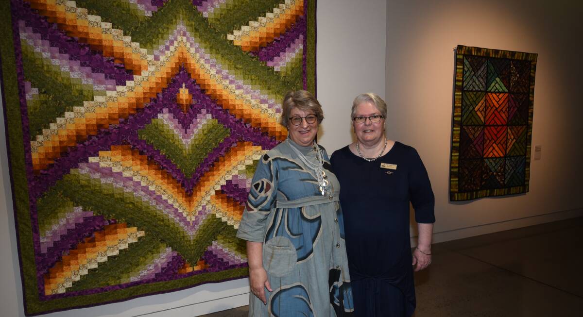 TRADITION: Studio Art Quilt Associates president Lisa Walton and Dubbo Patchwork and Quilters Group president Meg O'Brien at the exhibition. Photo: AMY McINTYRE