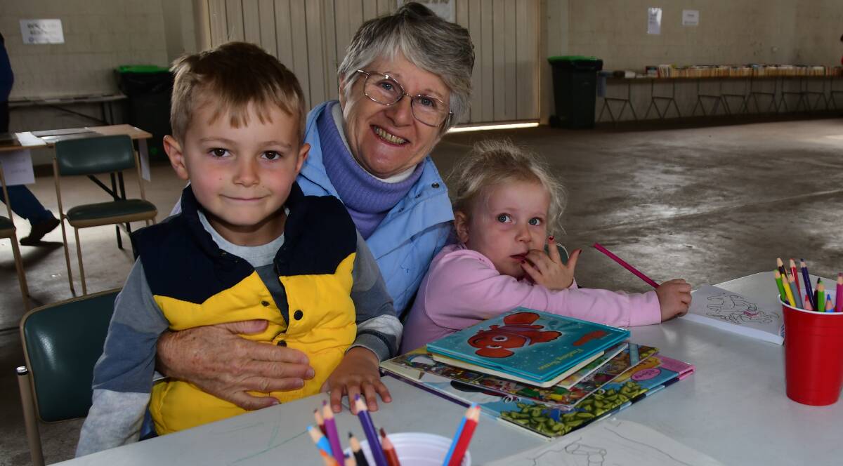 BOOKS FOR EVERYONE: Jack Vaile, Ann Gibson and Grace Vaile at last year's Rotary Book Fair, which was the first to be at the showground. Photo: AMY McINTYRE