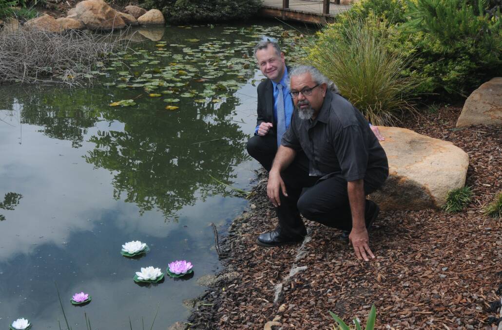 'MIRACULOUS': Mayor Ben Shields and Lewis Burns release lotus flowers at Elizabeth Park. Photo: ORLANDER RUMING