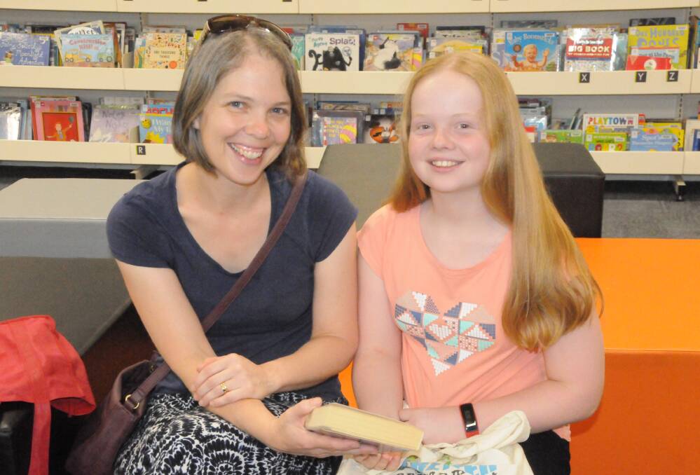 POPULAR PATTERSON: Kathryn Blanch and her daughter Beth Blanch, who was borrowing one of popular author James Patterson's novels. Photo: ORLANDER RUMING
