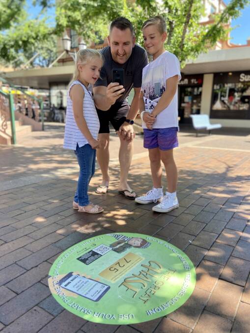FAMILY FUN: Dubbo councillor Dayne Gumley with his children Torah and Jacob trying the augmented reality game The Great Chase. Photo: CONTRIBUTED