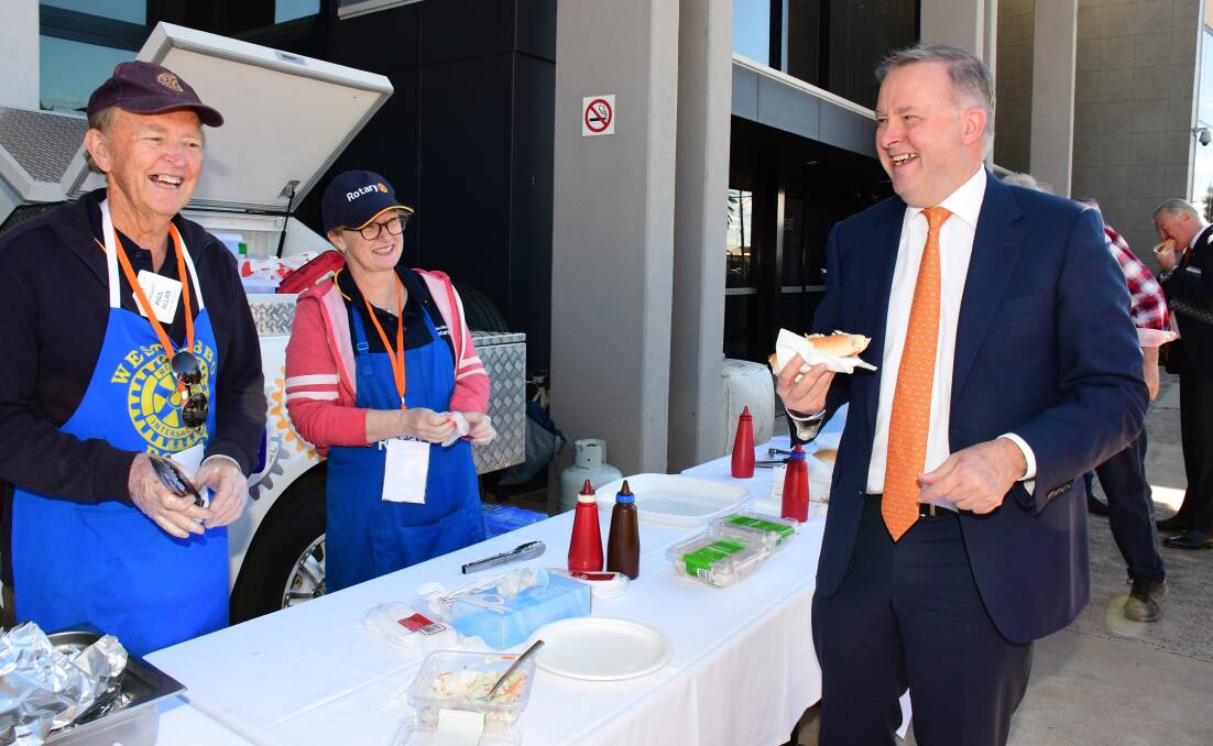 Dubbo West Rotary members Paul Allan and Genevieve Menzies serving Anthony Albanese. Photo: BELINDA SOOLE