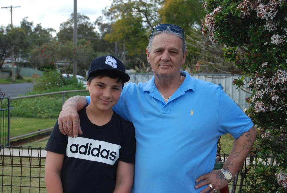 NEW LIFE: Steven Grainger (right) with grandson Jayden outside his Nyngan home. Mr Grainger is turning his life around after his difficult childhood plagued with horrific experiences. Photo: GRACE RYAN.