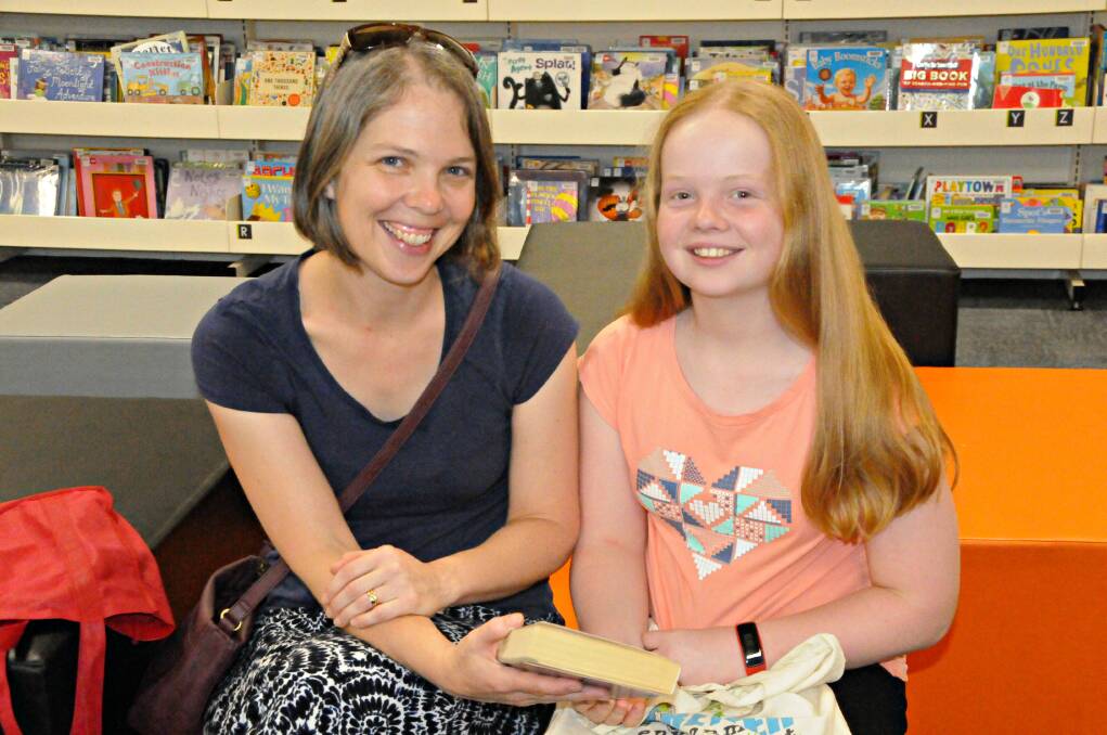 LIBRARY STILL RELEVANT: Kathryn Blanch and her daughter Beth Blanch borrowing a traditional book from the Dubbo branch of the Macquarie Regional Library recently. Photo: ORLANDER RUMING