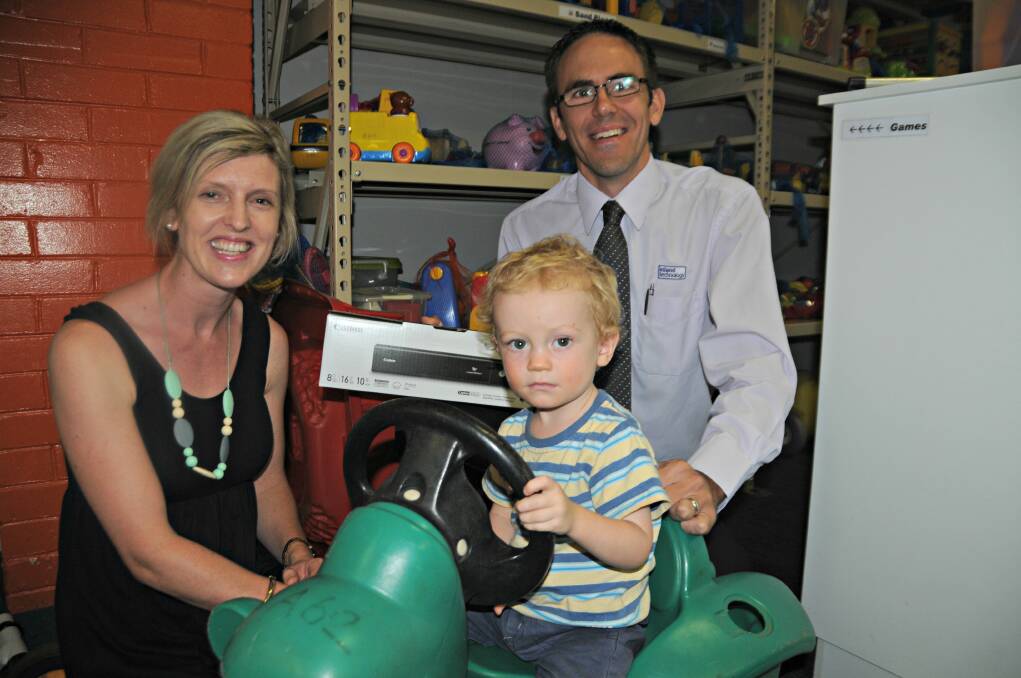DIGITAL DONATION: Jessica Simmons and Rob Sweeney said children like Harvey Simmons who use the Orana Toy Library would be better off now they had a scanner. Photo: ORLANDER RUMING