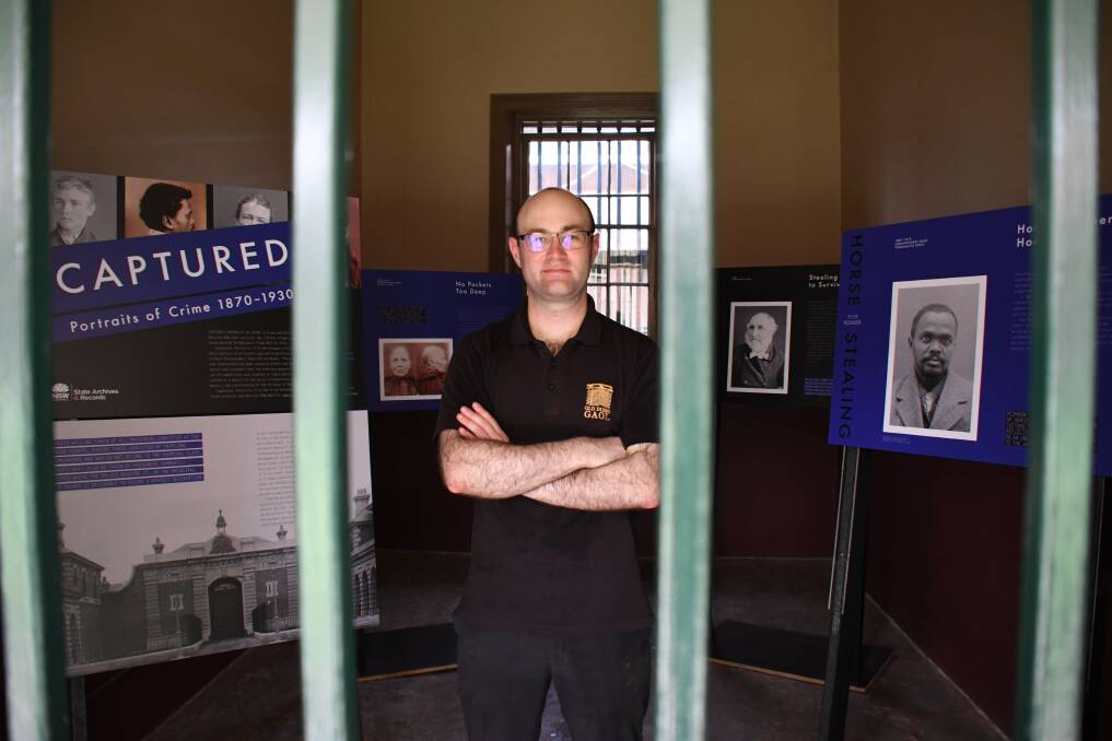 PORTRAITS OF CRIME: Old Dubbo Gaol’s visitor experience officer Chris Anemaat says extraordinary stories of ordinary people are covered in the exhibition. Photo: BELINDA SOOLE