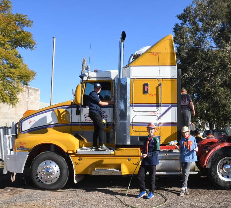 SQUEAKY CLEAN: Noah Lynch, Byron Lynch and Hamish Kerr from the 1st Dubbo Scouts Group cleaning one of he trucks which came through the car wash at the weekend. Photo: AMY McINTYRE