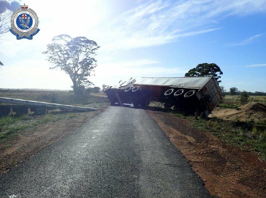 It is alleged a prime mover and lead trailer carrying the grain, rolled at the corner of the McGrane Way and Fairview Road near Narromine. Photo: NSW POLICE