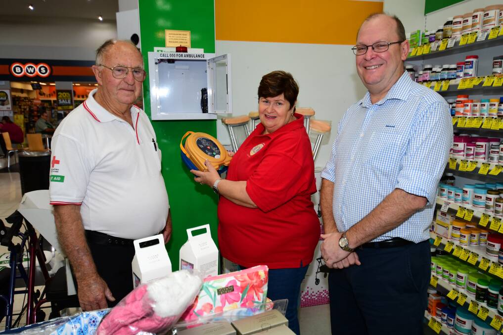 BE PREPARED: Australian Red Cross Dubbo first aid trainer George Chapman installing one of the defibrillators recently with Lois Hands and Ian Shepherdson. Photo: BELIDNA SOOLE
