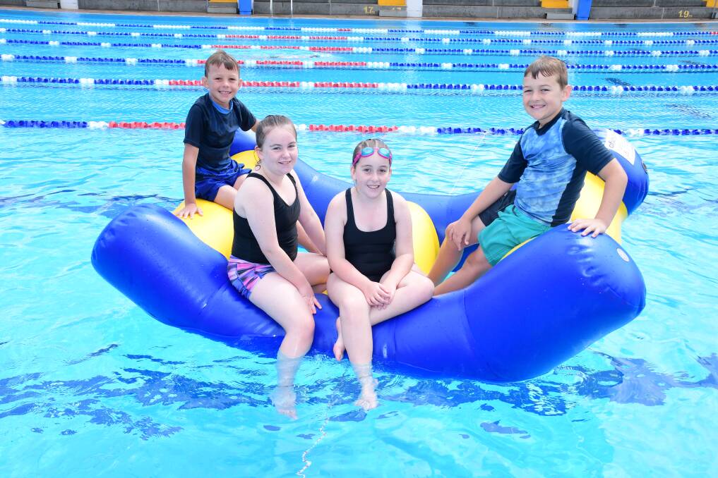 FUN IN THE SUN: Ayden Powyer, Briannah and Madalyn Hundy with Cameron McKenzie at Dubbo pool. Photo: AMY McINTYRE