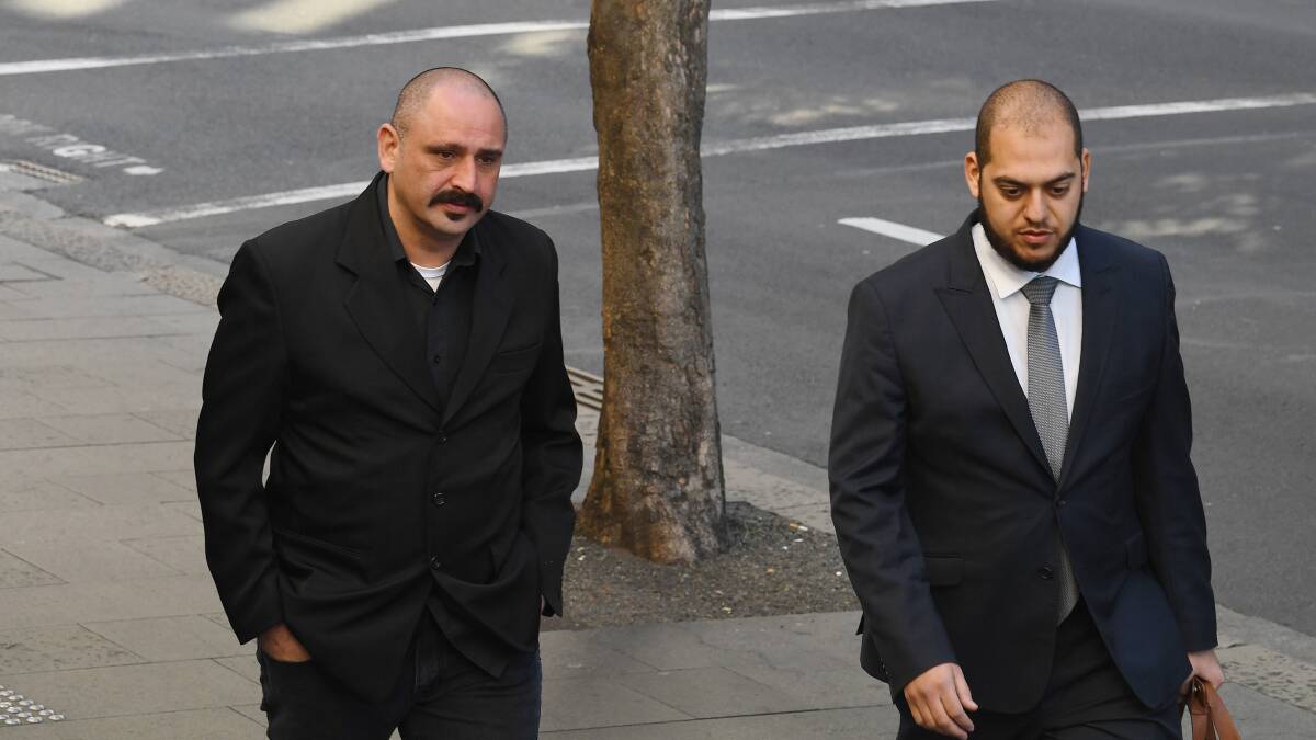 Khaled Merhi accompanied by his lawyer Moustafa Kheir, arriving at the Downing Centre for his first appearance. He's one of the men detained over the plot to blow up an aeroplane. Photo: LOUISE KENNEDY