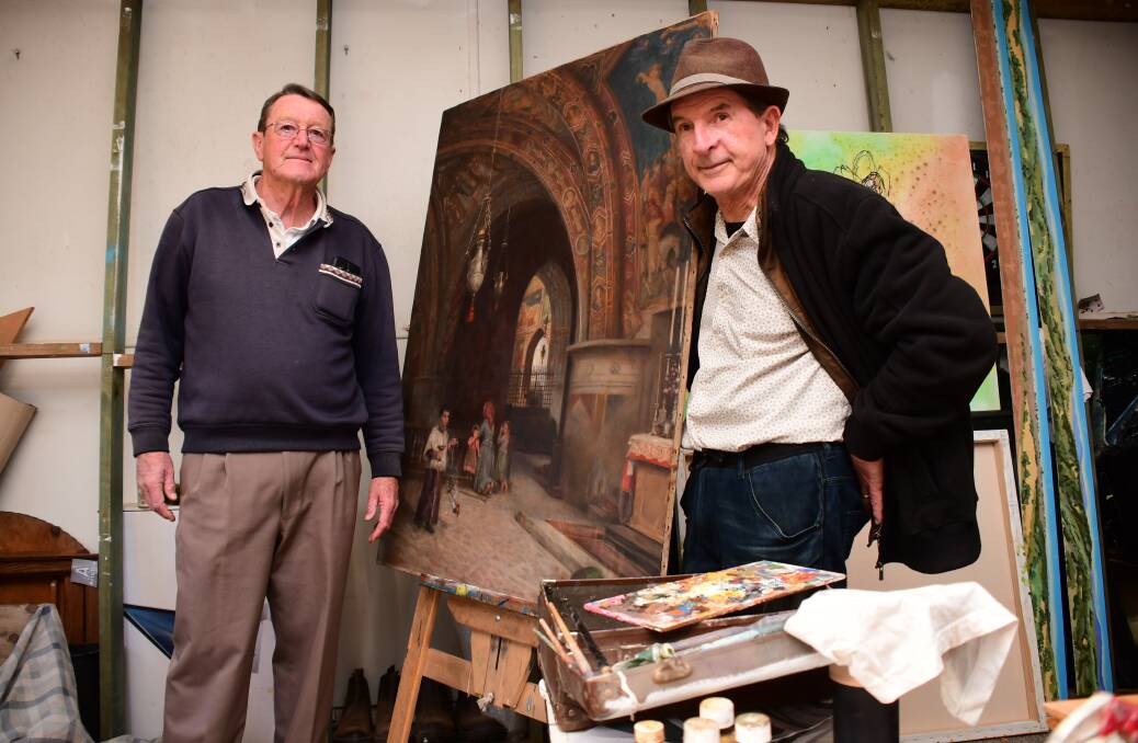 RESTORING THE PAST: The Holy Trinity Church's Bob McKeowen and artist Jack Randell beside the restored work. PHOTO: AMY MCINTYRE.