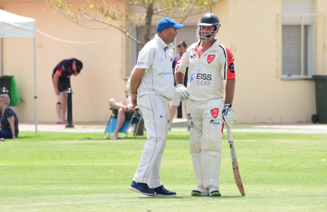 WORD TO THE WISE: Jason Green and Brad Cox share a word on Saturday, the two veterans will likely play deciding roles in the game's outcome. PHOTO: AMY MCINTYRE.